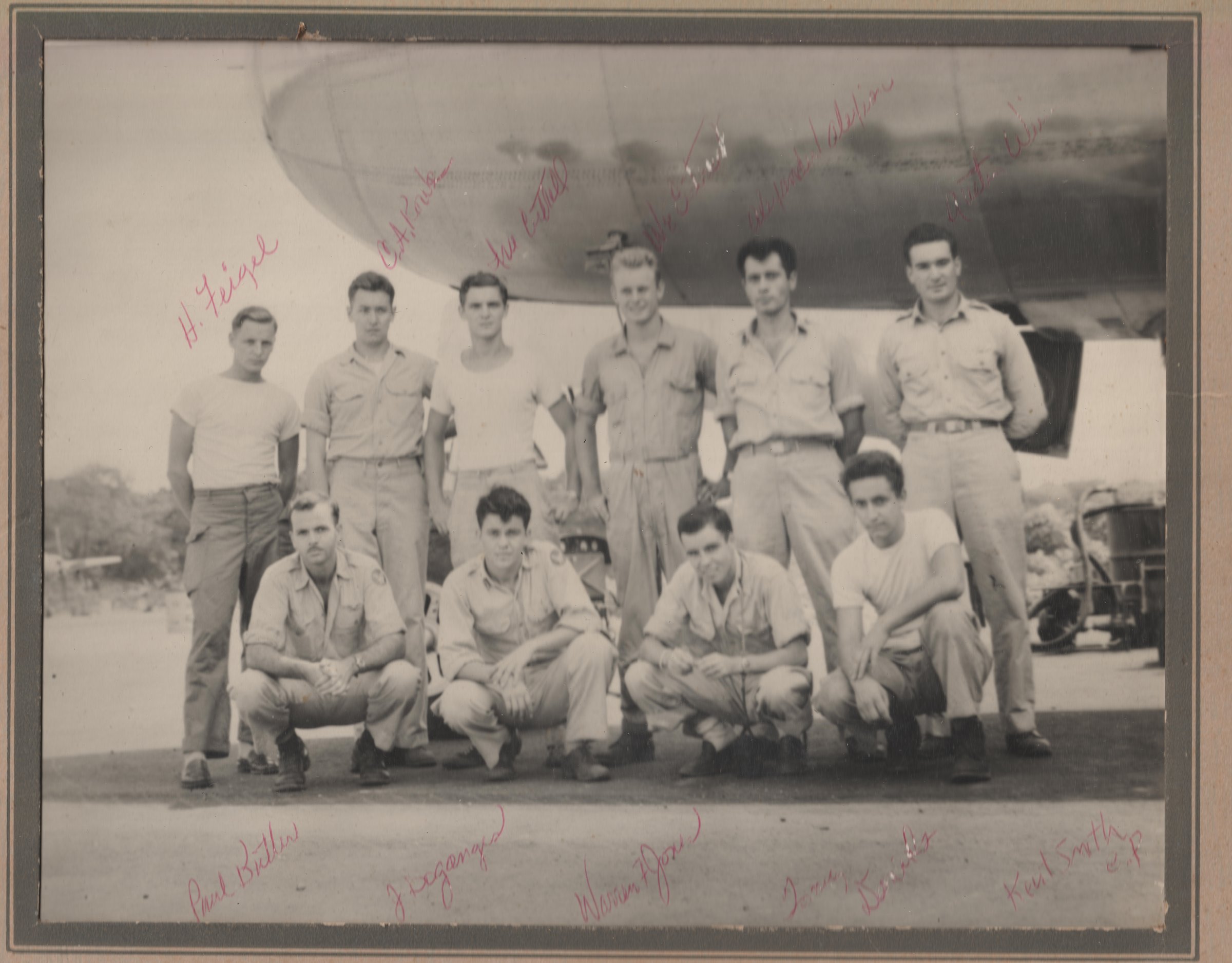 Signed wartime crew photograph beside a B-29 fuselage, believed to be City of Annapolis, July 1945